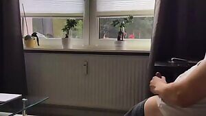 Exhibitionist jerks off in front of the window to an unsuspecting audience.