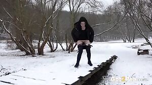 European dark haired cutie melting the snow with her warm pee