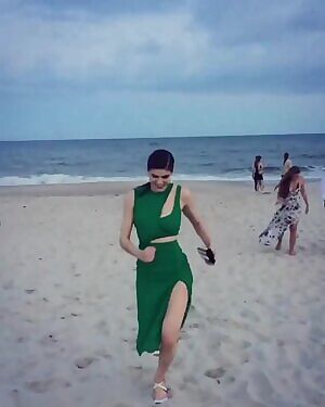 Alexandra Daddario running on the beach