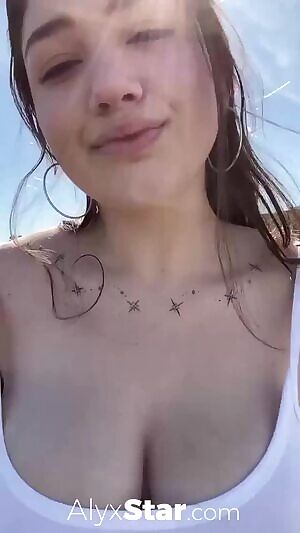 Alyx Star flashing in a parking lot