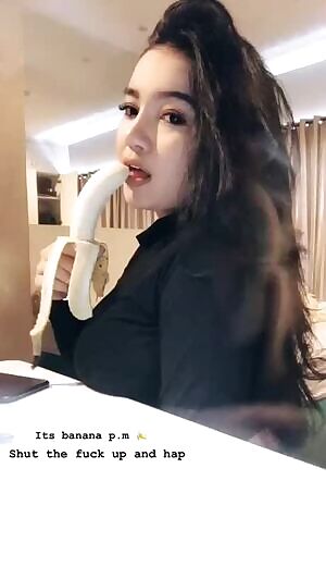 Hot Asian eating banana