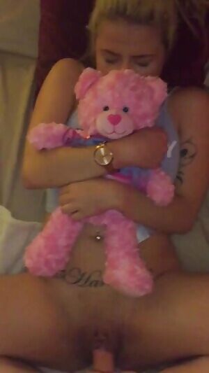 holding her teddy bear close by while she takes a thick cock
