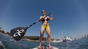 Erika Christensen paddling in a bikini.