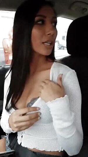 Flashing her sexy tits in the car