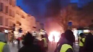 Protestor pays price for picking up a smoke grenade