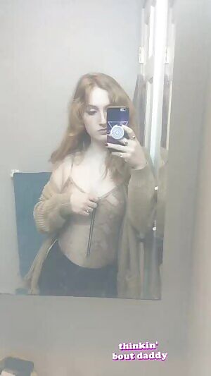 Girl shows her breasts in front of the mirror