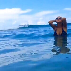 Viki Odintcova running in surf