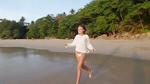 Stunning model Nicole Ross gets her thin white top wet at the beach