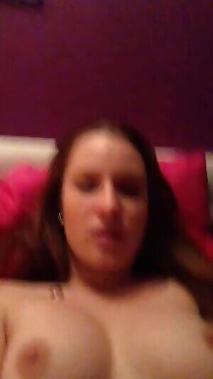 Girl pleasures herself with a red dildo