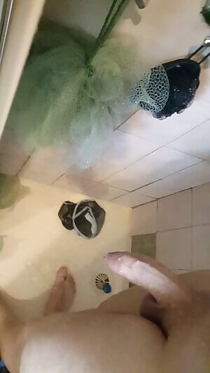 Playing with my dick under the shower water.