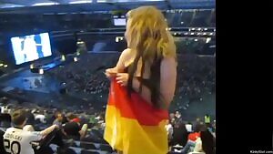 German girl flashes from the last row in a stadium