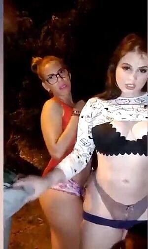 Two girls and a guy try to have sex on the street at night.